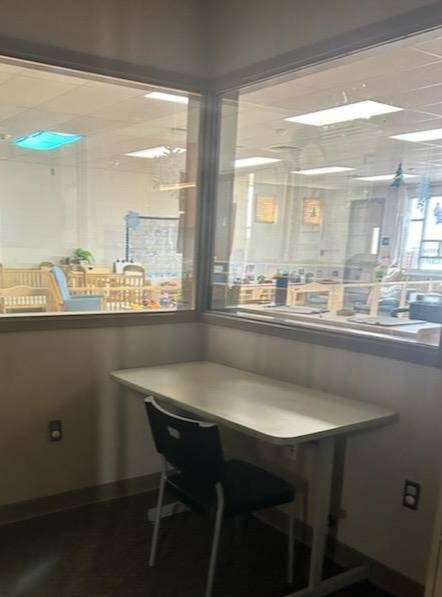 interior office window view of infant cribs