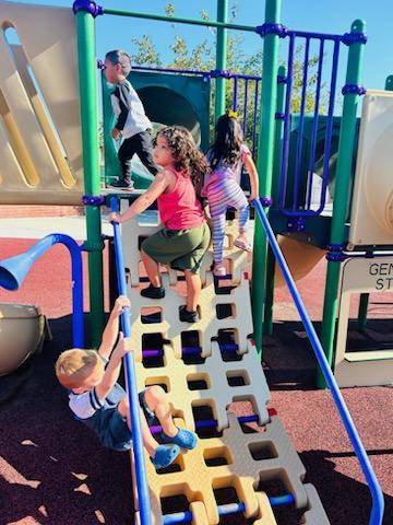 children climbing on playground equipment