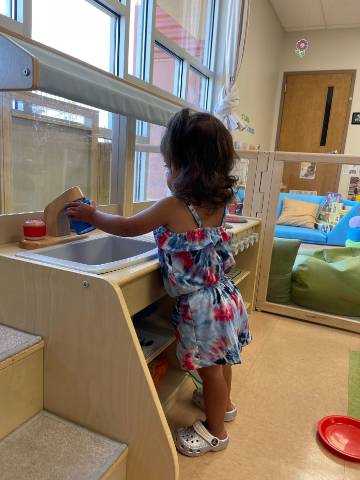 child at play sink in miniature kitchen