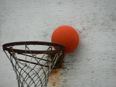 basketball stuck between rim and backboard